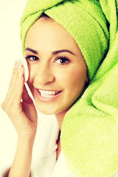 Portrait of a woman in bathrobe removing makeup — Stock Photo, Image