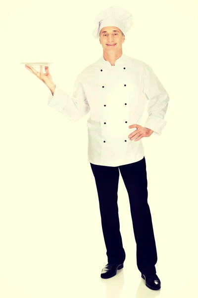 Chef holding white porcelain plate — Stock Photo, Image