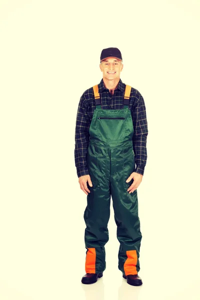 Mature gardener standing in uniform — Stock Photo, Image