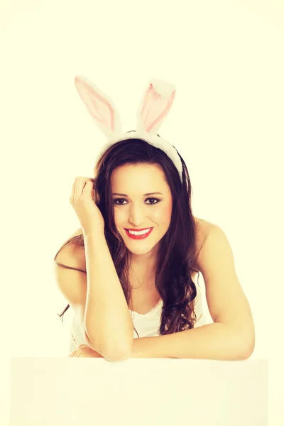 Portrait of lying woman wearing bunny ears — Stock Photo, Image