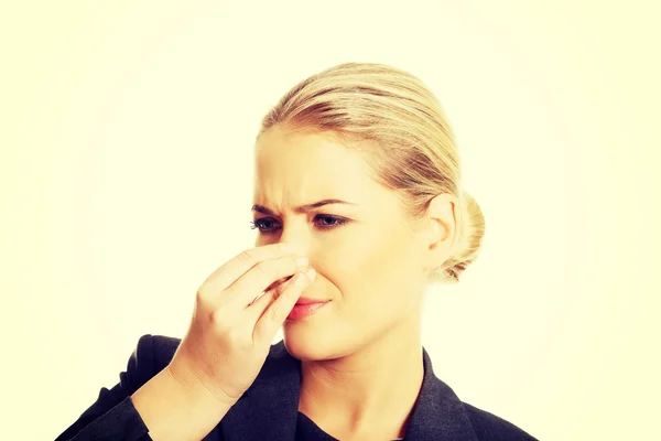 Woman pinching her nose because of disgusting smell — Stock Photo, Image