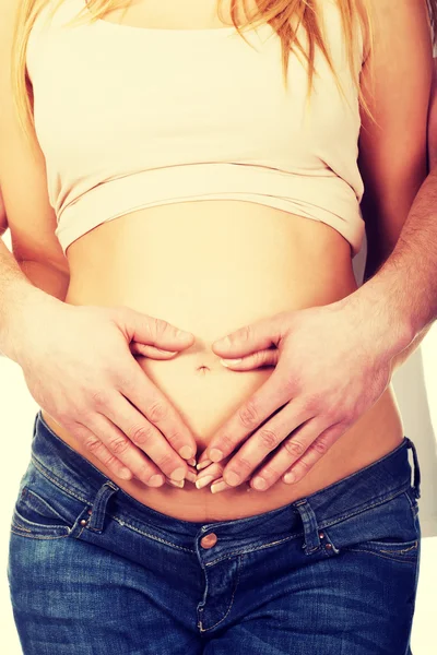 Man embracing her wifes pregnancy belly — Stock Photo, Image