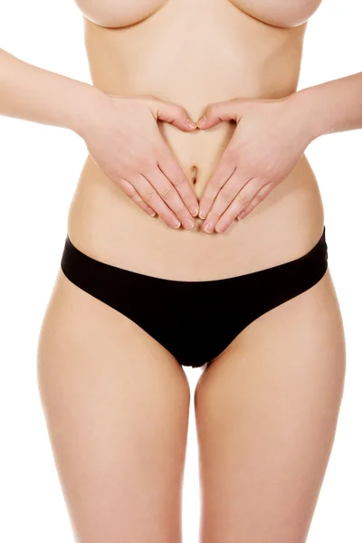 Frau mit den Händen auf dem Bauch. — Stockfoto