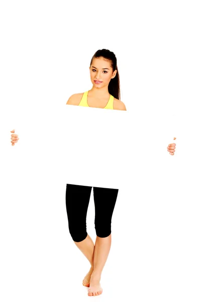 Fitness woman with empty placard. — Stock Photo, Image