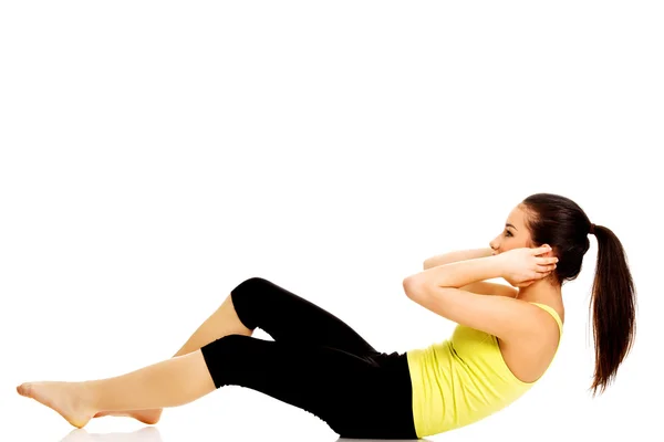 Woman exercising and doing a crunch. Royalty Free Stock Photos