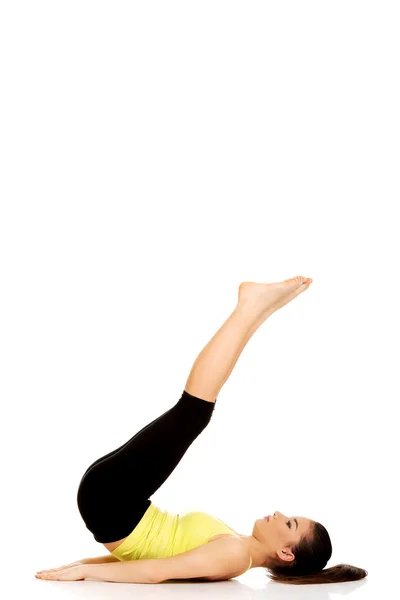 Fitness woman with her legs up. Stock Photo