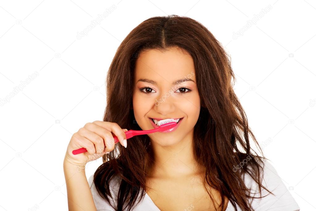 Beautiful teen brushing her teeth.