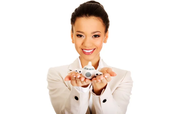 Businesswoman holding small plane on palm. — Stock Photo, Image