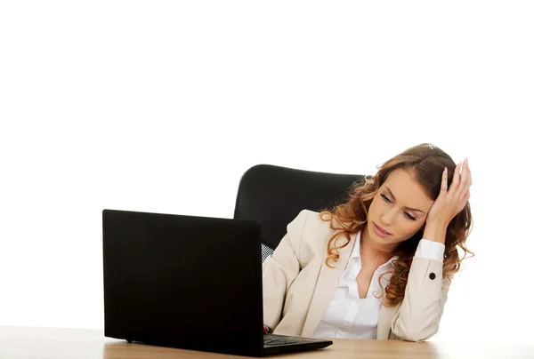 Tired businesswoman working on laptop. — Stock Photo, Image