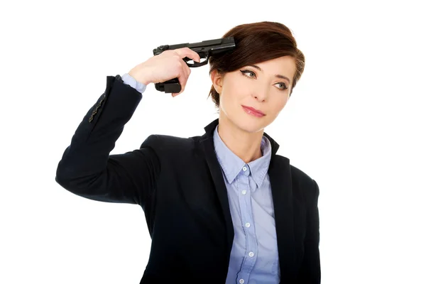 Woman in business suit holding a gun. Stock Photo
