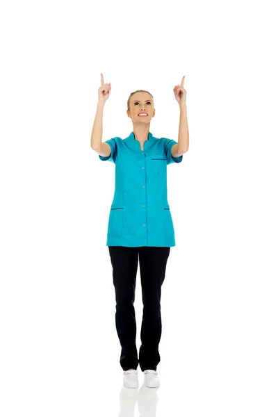 Female doctor pointing up. — Stock Photo, Image