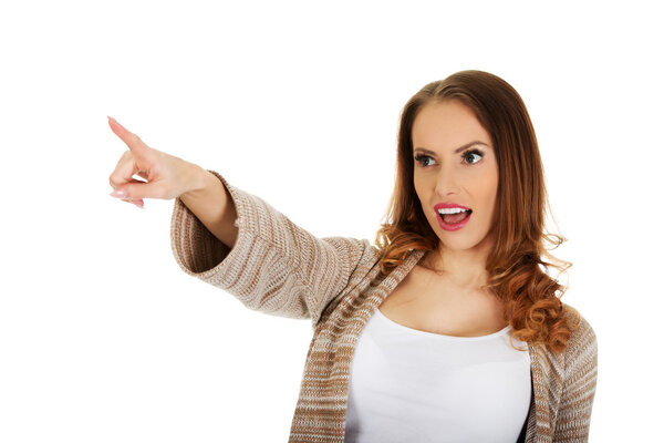 Shocked woman pointing away.