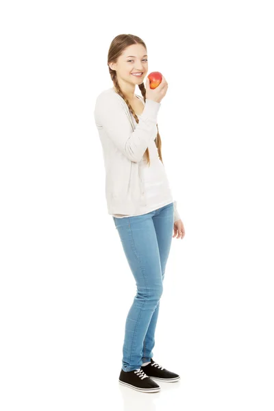 Teenage woman holding an apple. — Stock Photo, Image