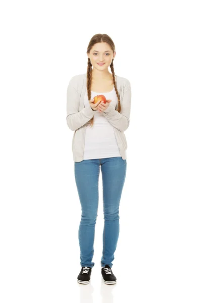 Teenage woman holding an apple. — Stock Photo, Image