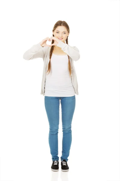Teenager making heart shape with hands. — Stock Photo, Image