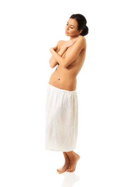 Woman standing wrapped in towel — Stock Photo, Image