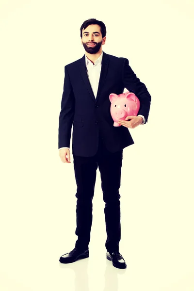 Biznesmen posiadający Piggy Bank. — Zdjęcie stockowe