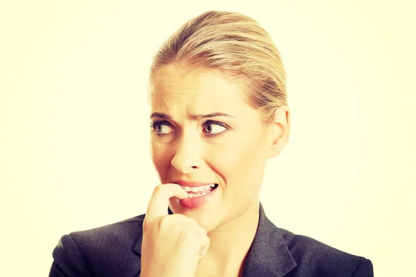 Stressed young woman biting her nails — Stock Photo, Image