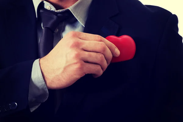 Empresário com modelo de coração no bolso . — Fotografia de Stock