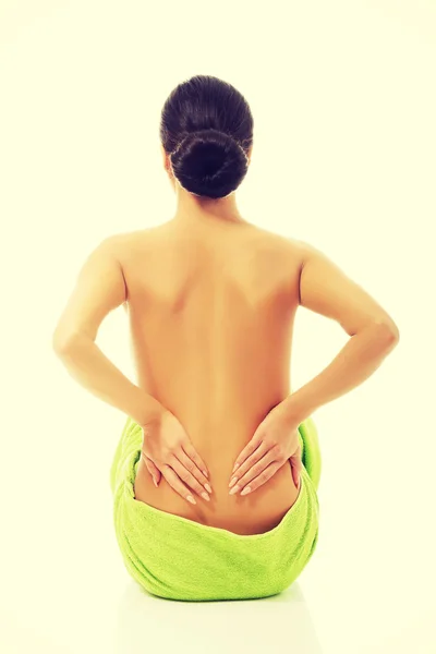 Back view woman sitting wrapped in towel — Stock Photo, Image