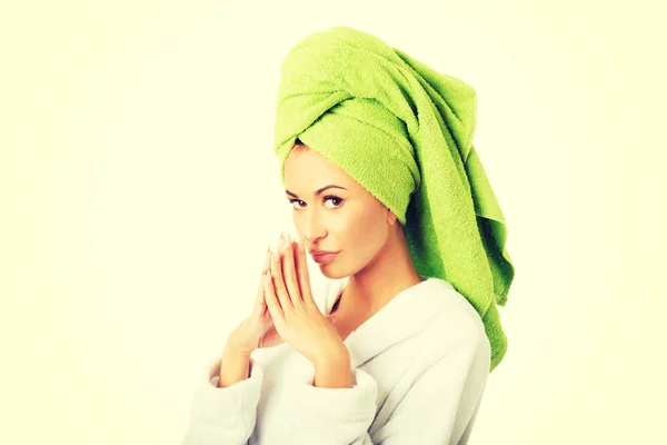 Woman in bathrobe clenching hands — Stock Photo, Image