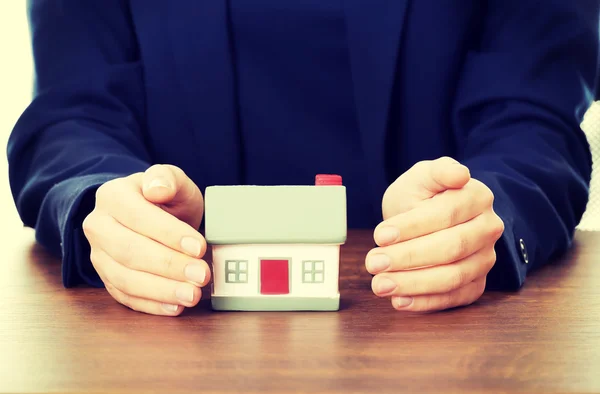 Businesswoman presenting a model house Stock Image