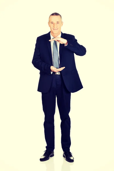 Full length businessman holding invisible product — Stock Photo, Image