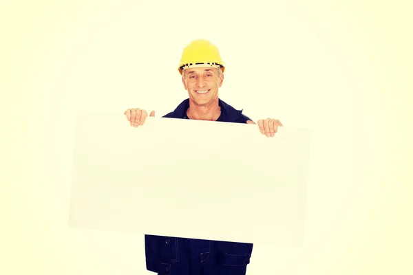 Happy worker presenting empty banner — Stock Photo, Image