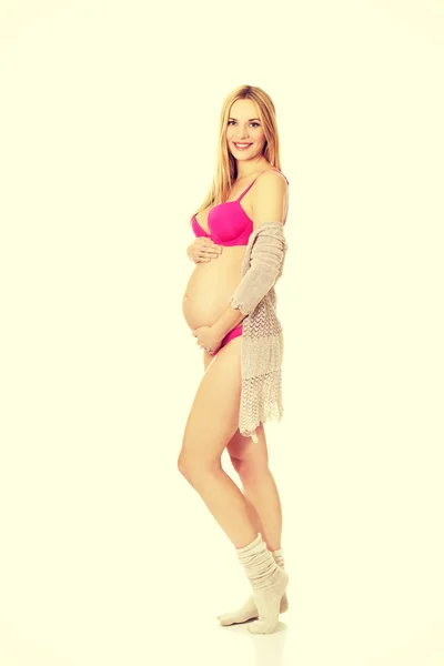 Pregnant woman in lingerie and socks — Stock Photo, Image