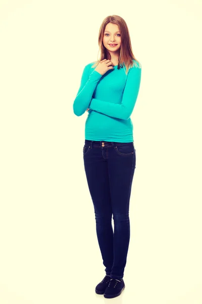 Young woman standing with toothy smile — Stock Photo, Image