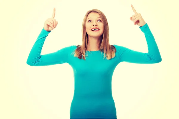 Young woman pointing up with both hands — Stock Photo, Image