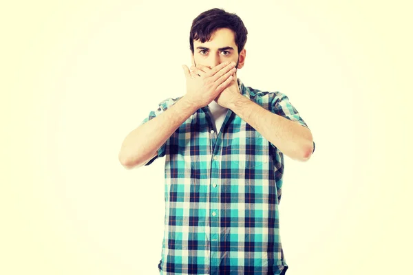 Young shocked man covering his mouth. — Stock Photo, Image