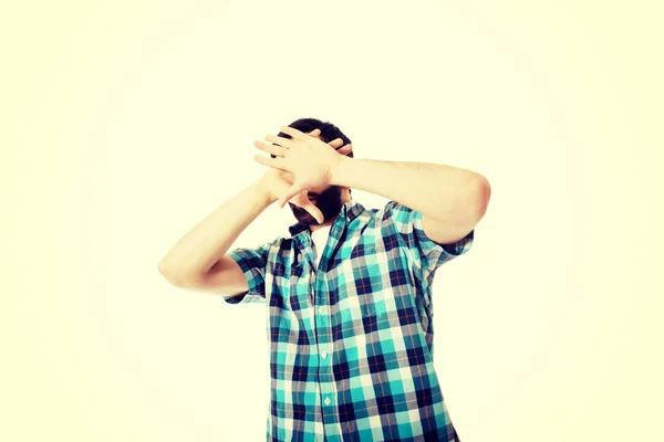 Young afraid man covering his face. — Stock Photo, Image