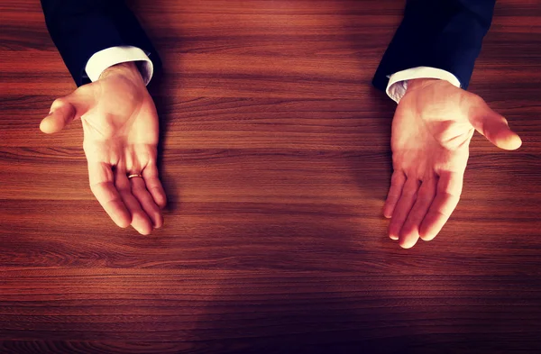 Close up of businessman open hands on the desk — Stock Photo, Image