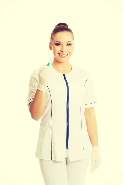 Female dentist holding a syringe — Stock Photo, Image