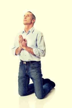 Man kneeling and praying to God