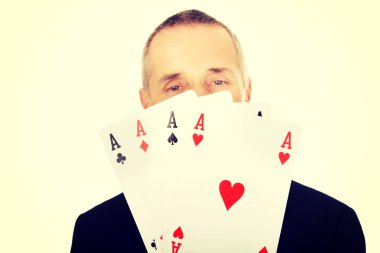 Portrait of elegant man with four aces
