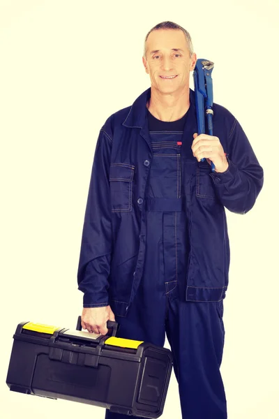 Mature worker with tools bag and wrench — Stock Photo, Image