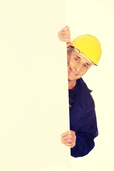 Happy worker presenting empty banner — Stock Photo, Image