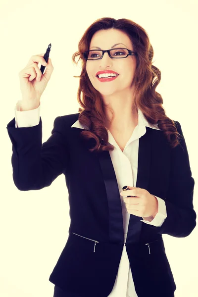 Businesswoman writing with pen on abstract screen. — Stock Photo, Image