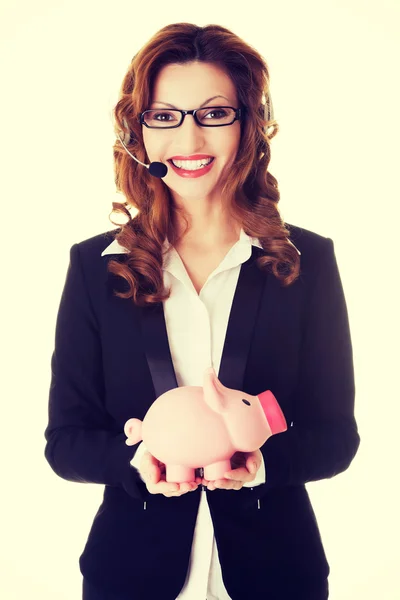 Happy call center woman with piggy bank. — Stock Photo, Image