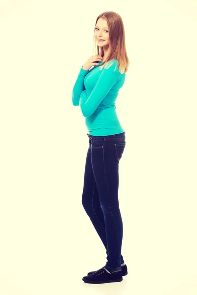 Young woman standing with toothy smile — Stock Photo, Image