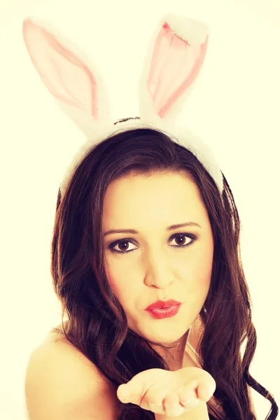 Woman wearing bunny ears and blowing a kiss — Stock Photo, Image