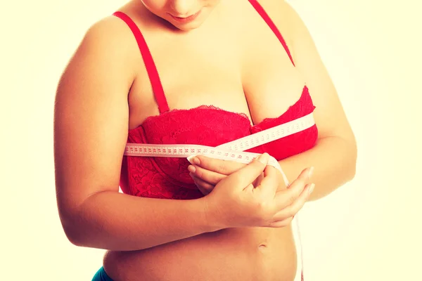 Fat woman measuring breast — Stock Photo, Image