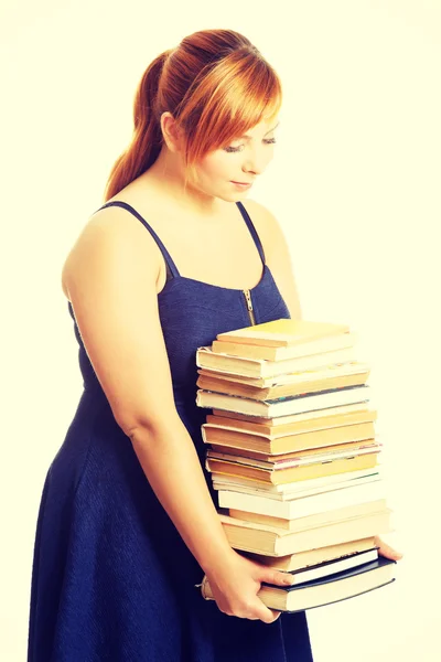 Overweight woman holding books — Stock Photo, Image