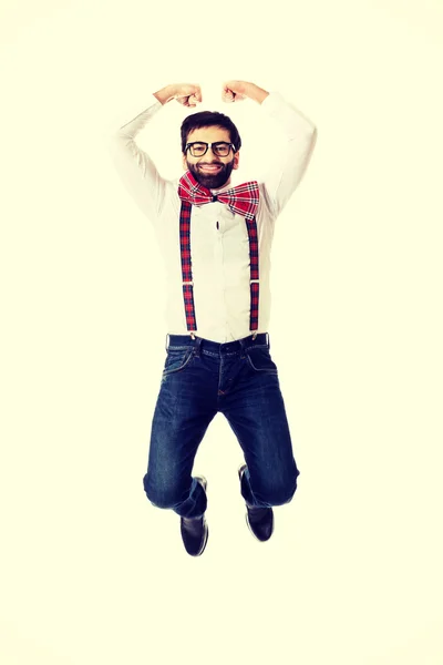 Old fashioned man wearing suspenders jumping. — Stock Photo, Image