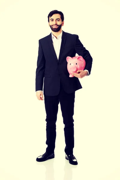 Biznesmen posiadający Piggy Bank. — Zdjęcie stockowe