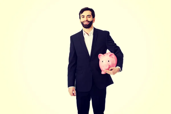 Biznesmen posiadający Piggy Bank. — Zdjęcie stockowe