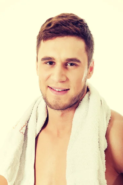 Young athletic man with a towel. — Stock Photo, Image