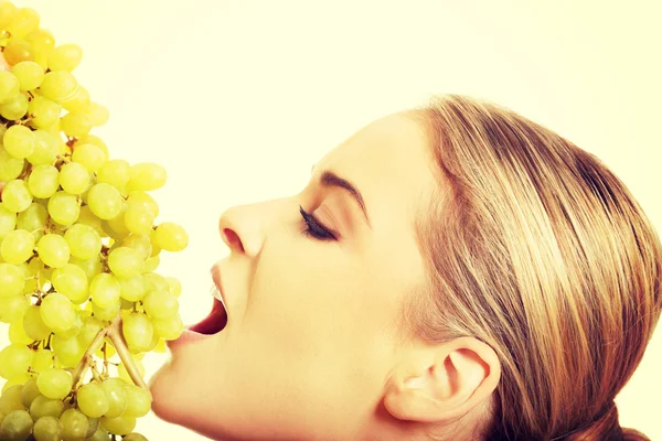 Portrait of nude woman eating grapes — Stock Photo, Image